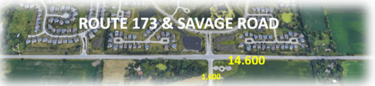 Aerial view of Route 173 and Savage Road with white text and a yellow number, over a rural landscape.