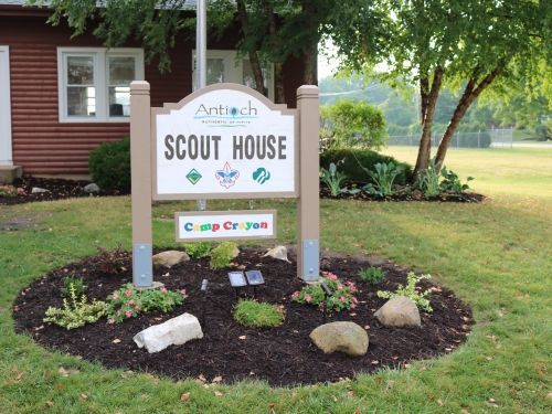 Sign for Scout House at Camp Croyan, with logo and landscaping.