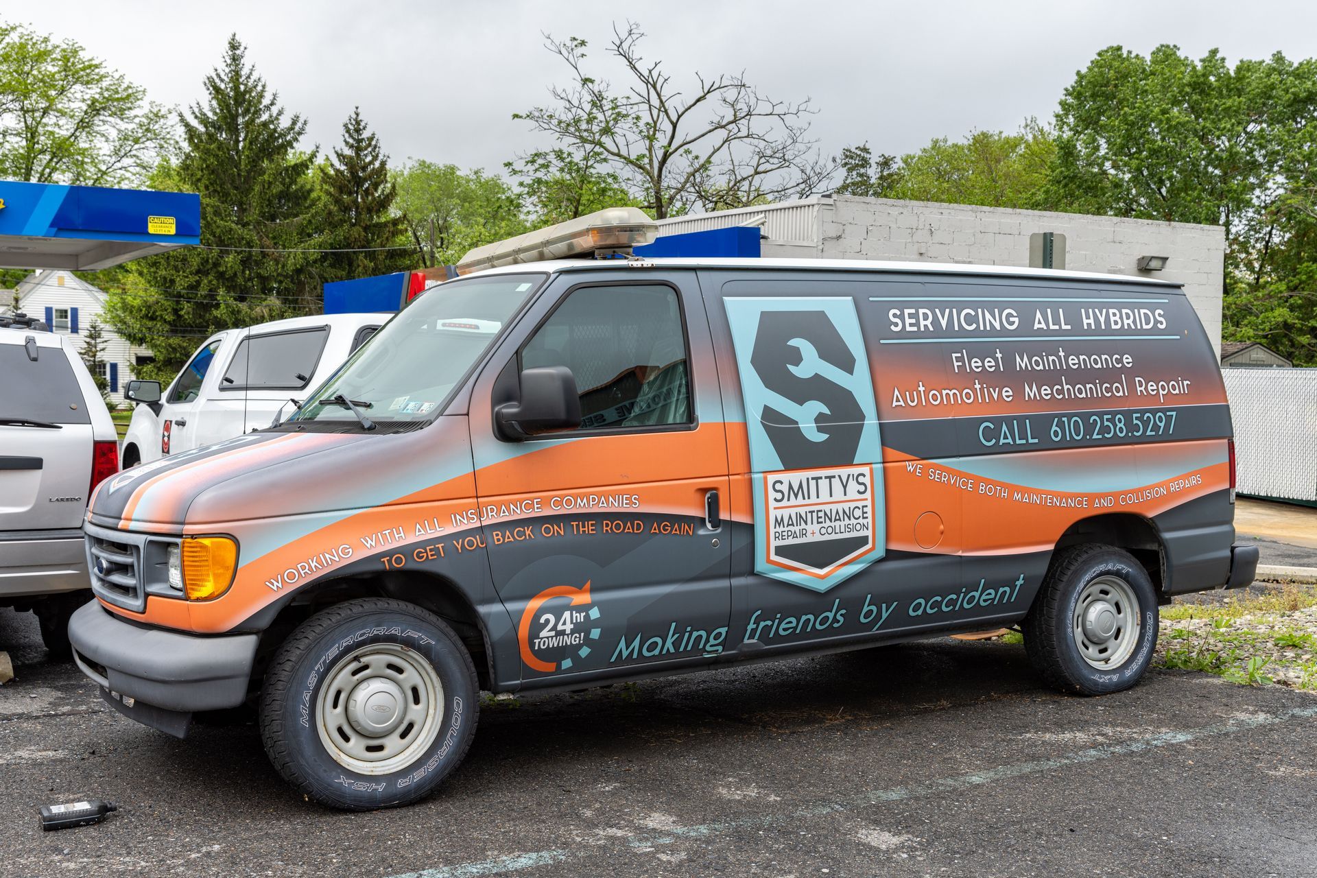 A work van with orange and grey paint, branded 
