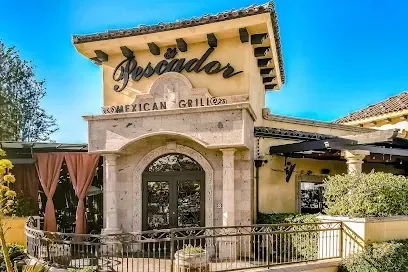 A large building with a sign that says ' pescador american grill ' on it.
