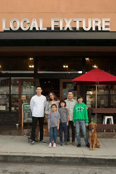 A family is posing for a picture in front of a local fixture restaurant.