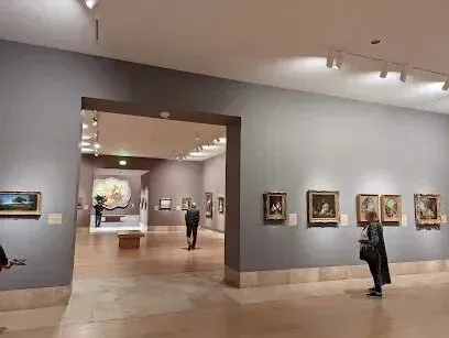 tree service close to me-Museum interior: People viewing paintings on walls, other rooms visible through doorways.