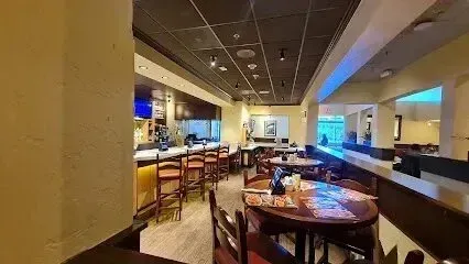 tree service close to me-Interior of a restaurant with a bar, tables, and chairs.