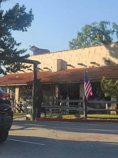A car is parked in front of a building with an american flag