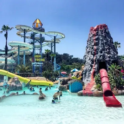 A water park with a volcano and a water slide.