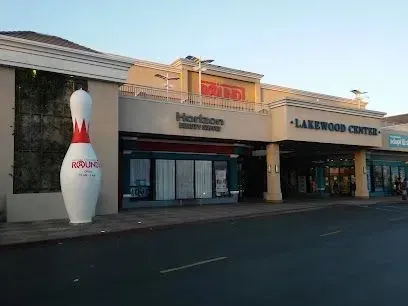 Tree service close to me-Splash pad with train, water tower, and shade structure; blue and colorful.