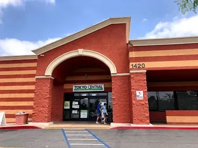 A store front with a handicapped parking spot in front of it.