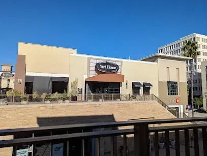 A view of a restaurant from a balcony with a blue sky in the background.