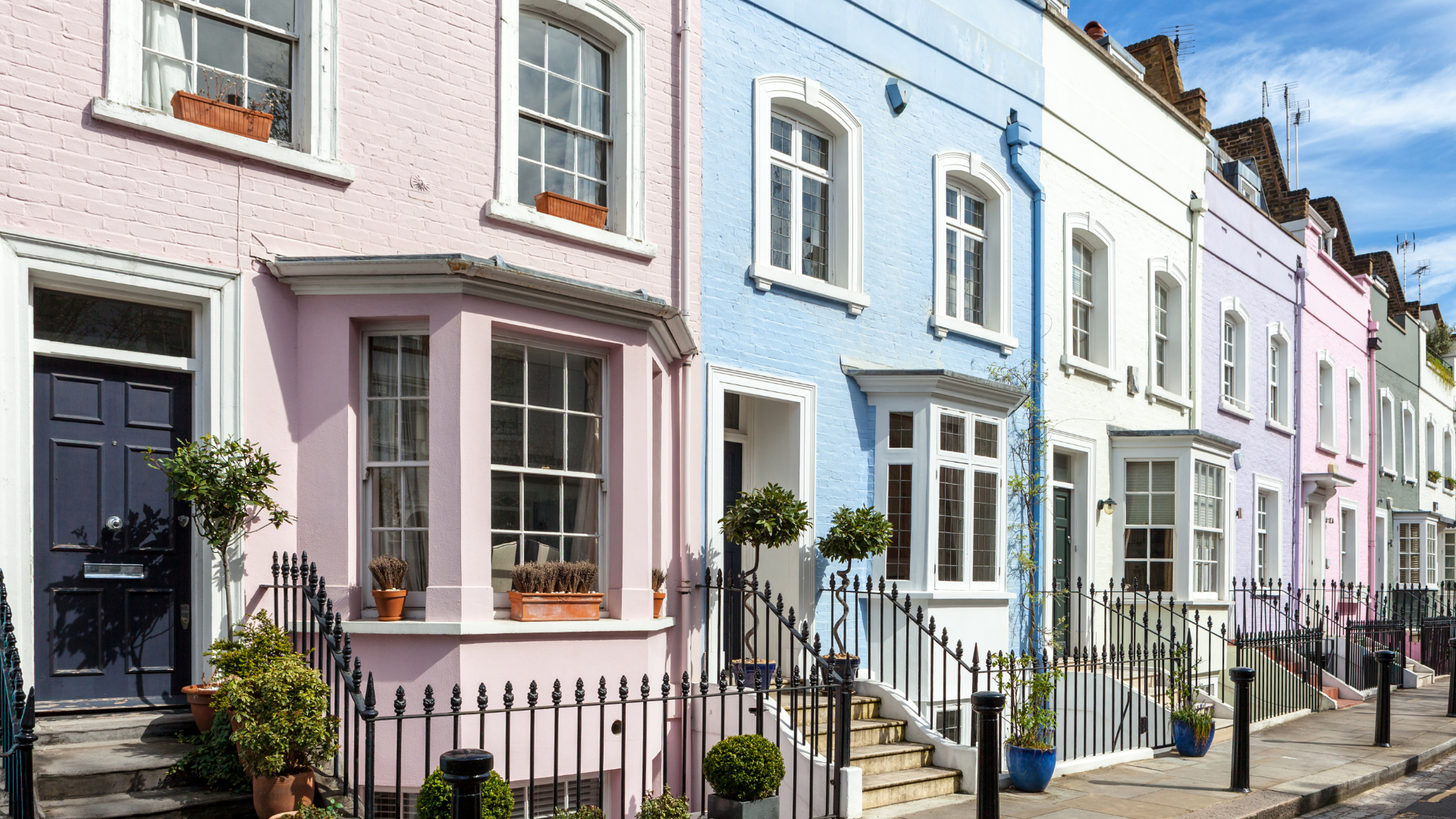 A row of colorful houses on a sunny day.