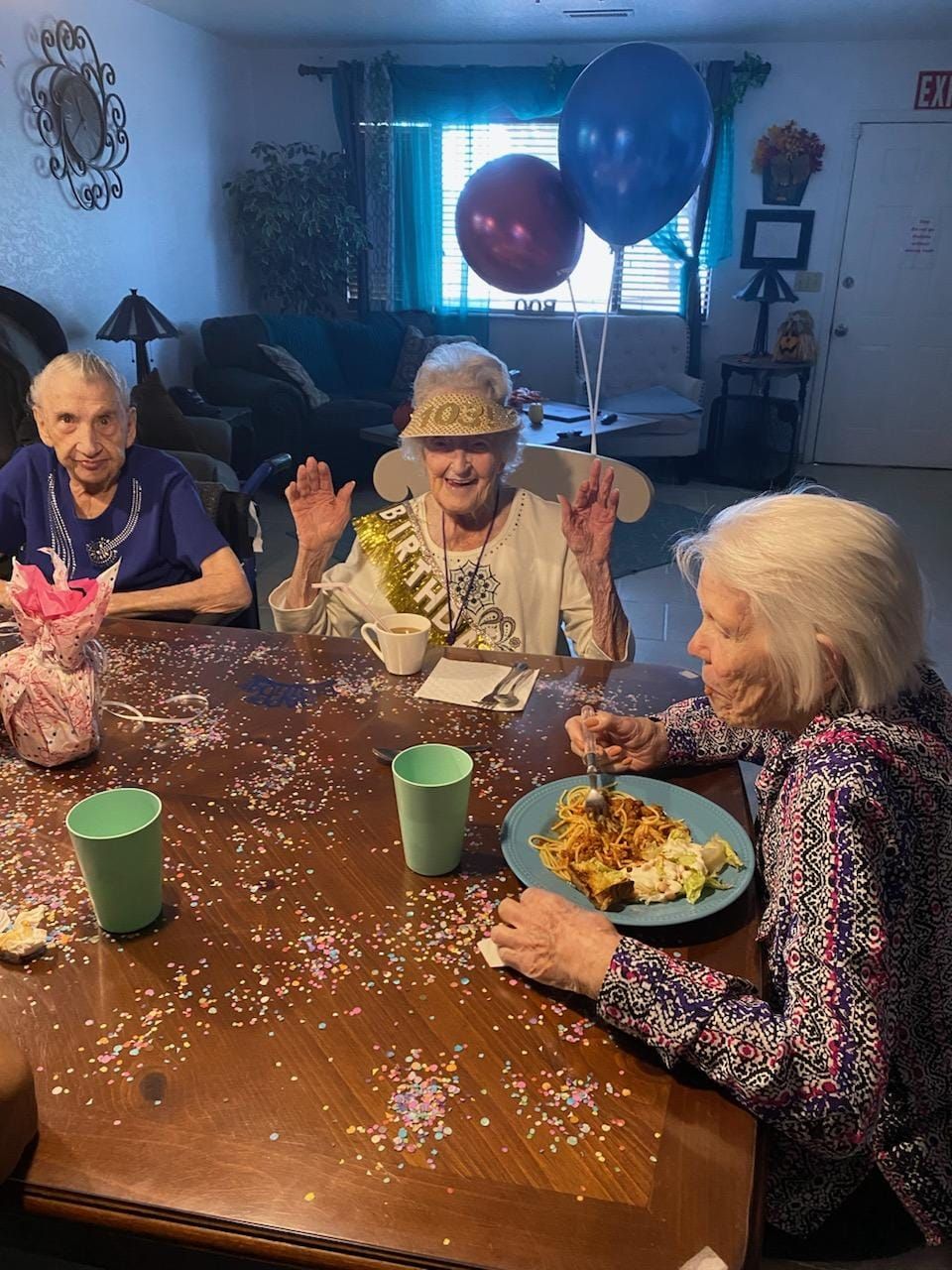 Three elderly women at a table.