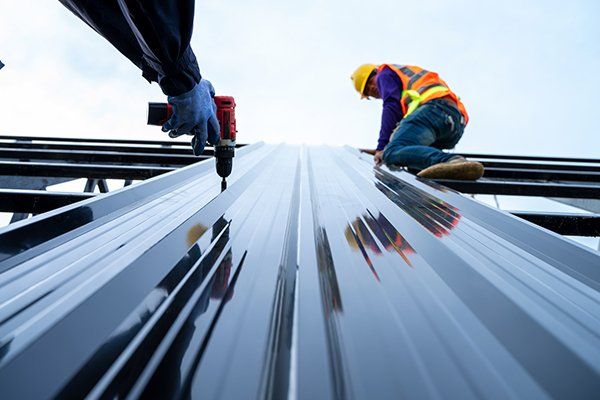 Roofer Installing New Roof Using Pneumatic Nail Gun — Etowah, NC — John Balken Jr. Roofing Company