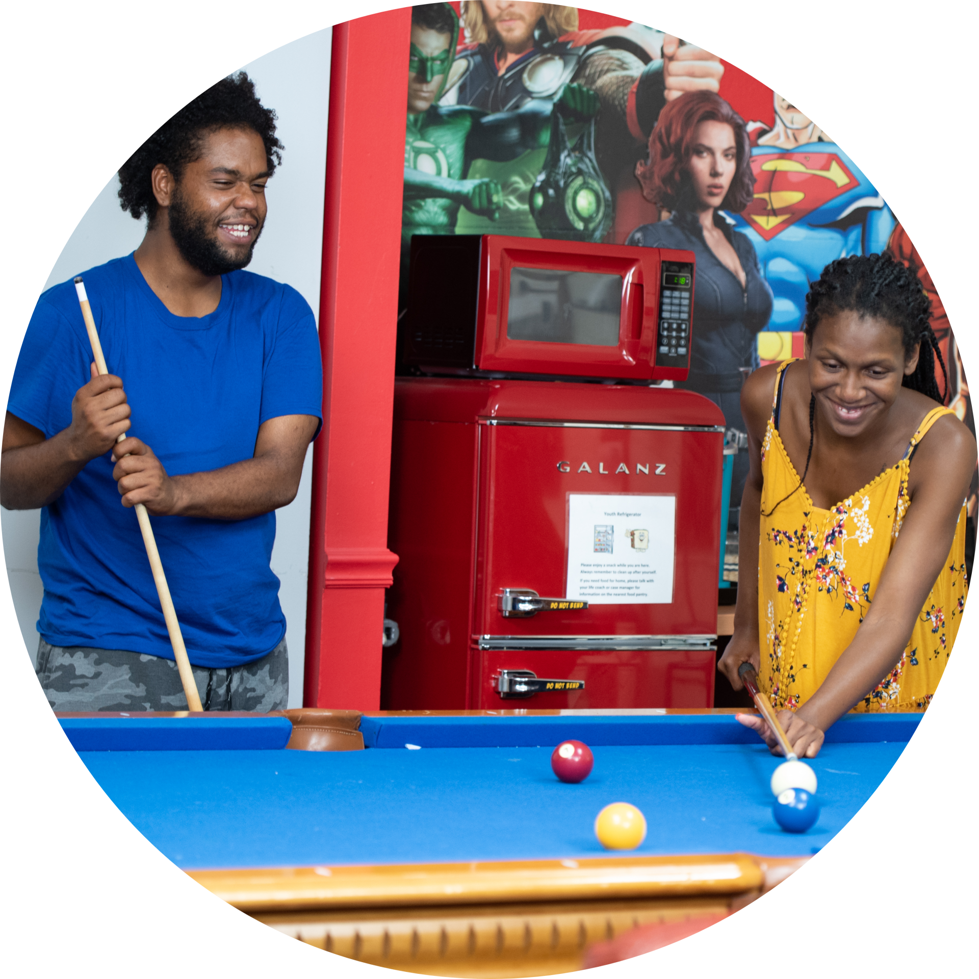 young man and woman playing pool