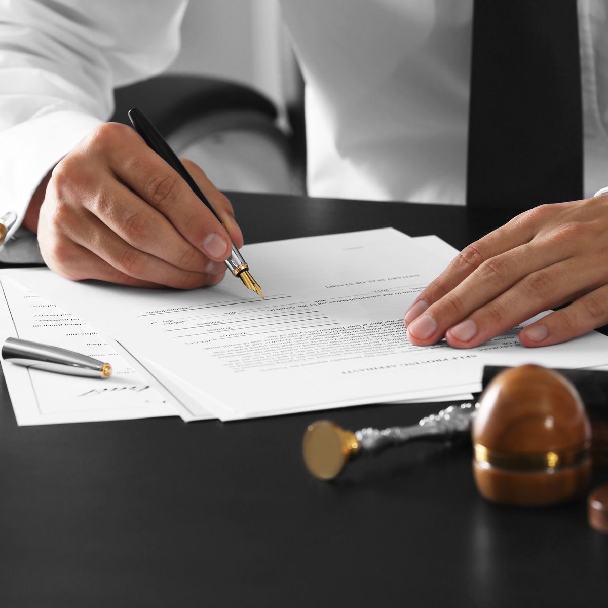 a person is writing on a piece of paper with a pen