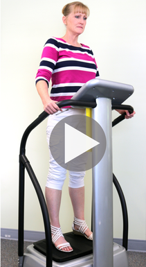 A woman is standing on a machine with a play button in the corner.