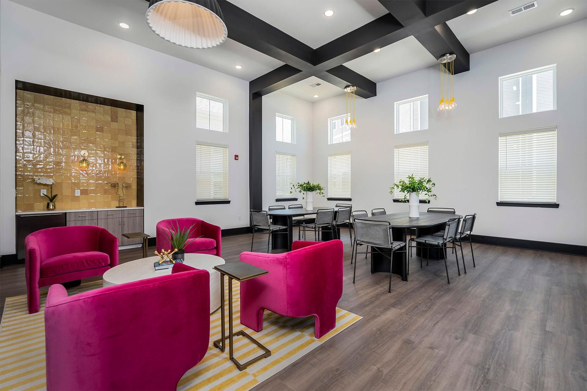 A modern dining room with a glass wall and a wooden floor.