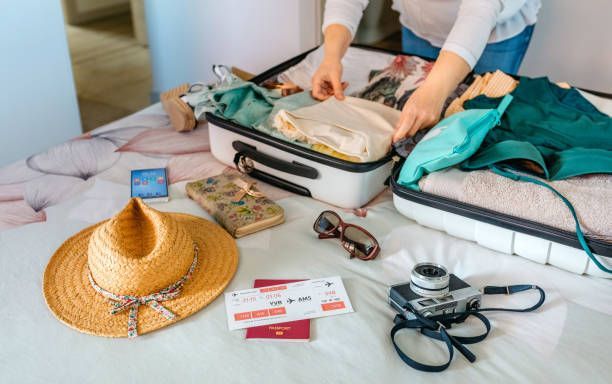 Woman is Packing a Suitcase on a Bed — Clear Spring, MD — Nicole Myers, Leroy Myers & Associates