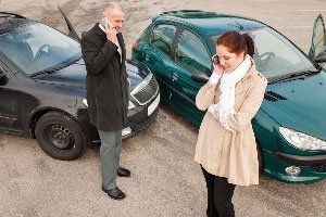 Professional Repair — Man and Woman Calling After Collision in Raleigh, NC