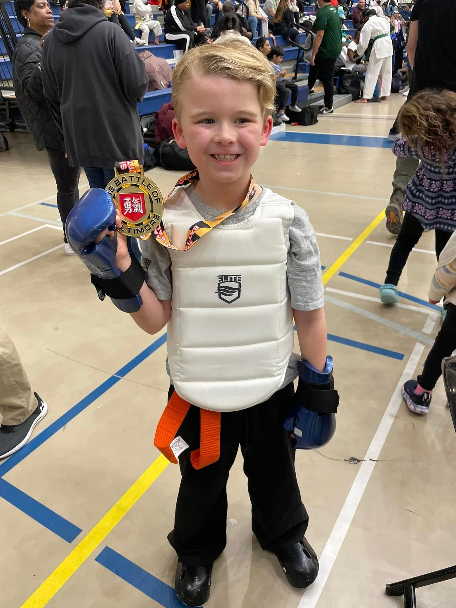 A person is holding a sparkler in their hand in the dark.
