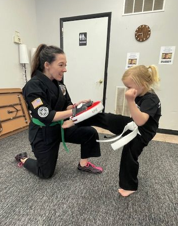 A person is holding a sparkler in their hand in the dark.