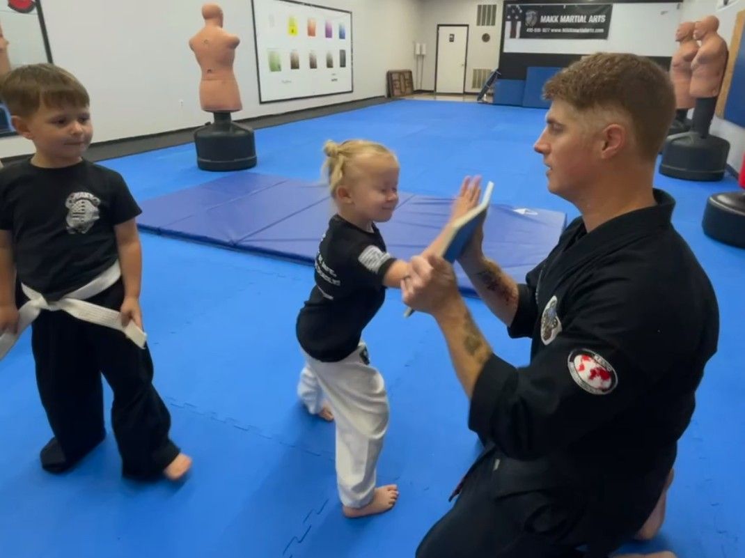 A person is holding a sparkler in their hand in the dark.