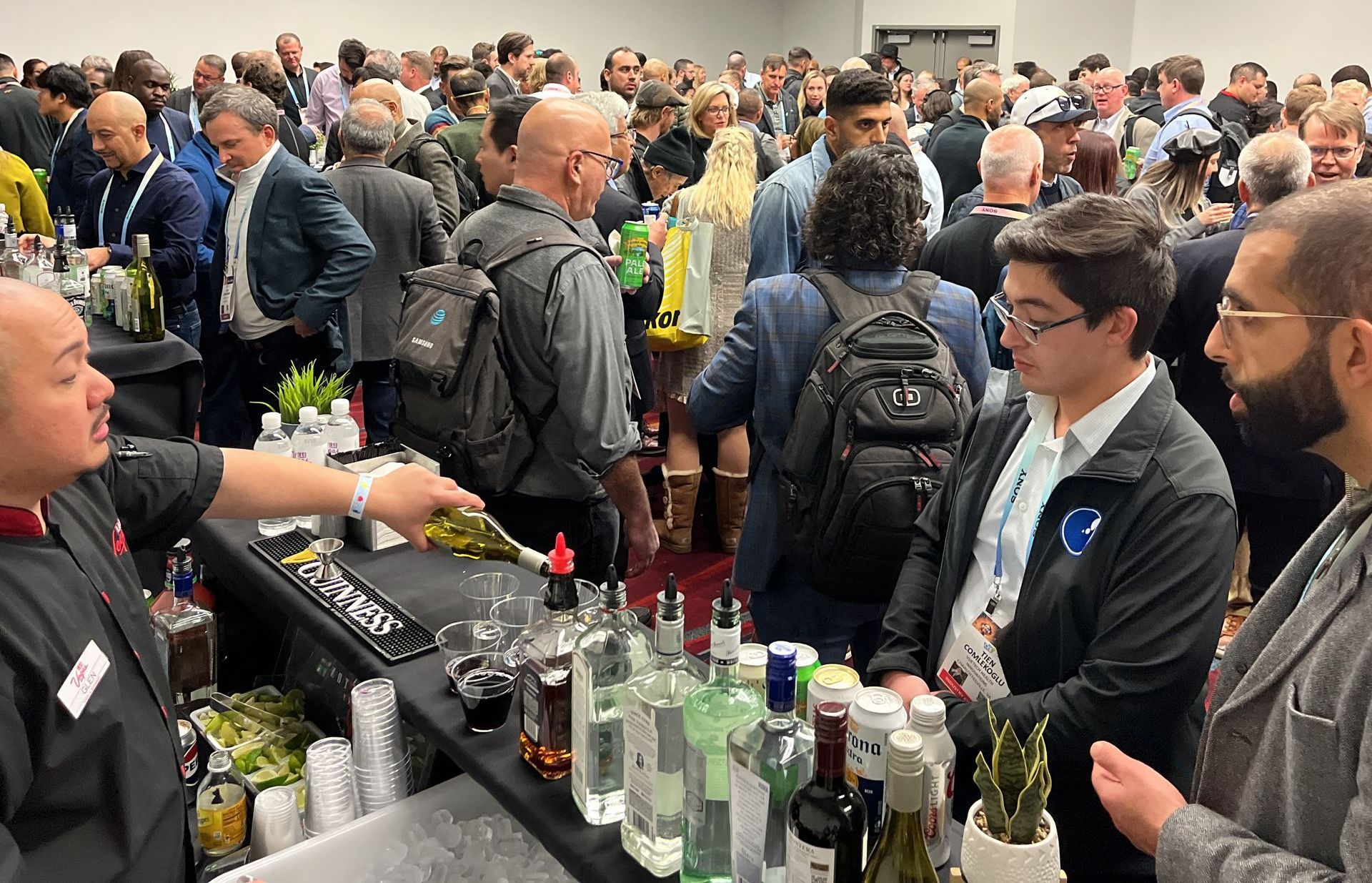 a large group of people are gathered in a room with a table