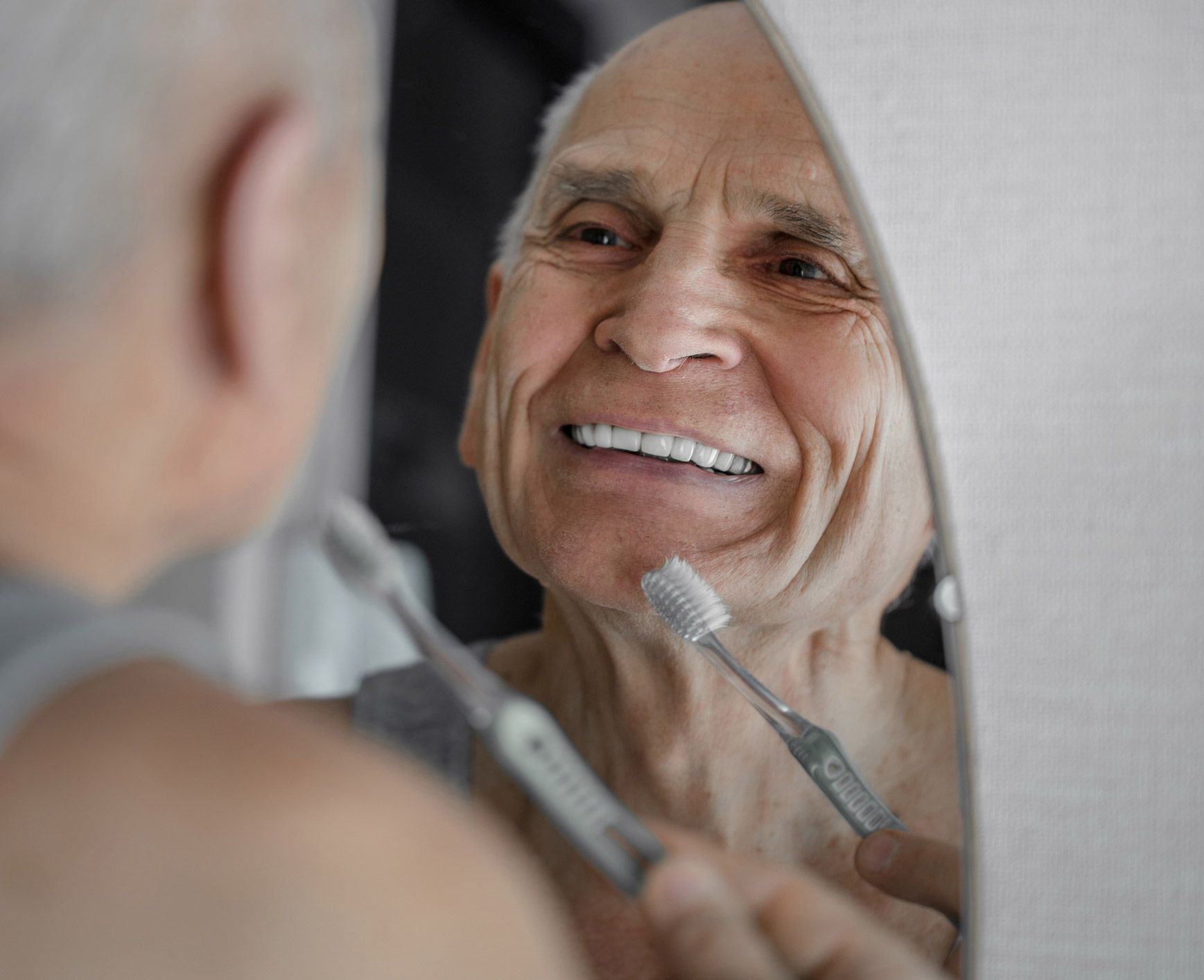 Smiling old man brushing his teeth | Hoppers Crossing, VIC | Matrix Dental Denture Clinic