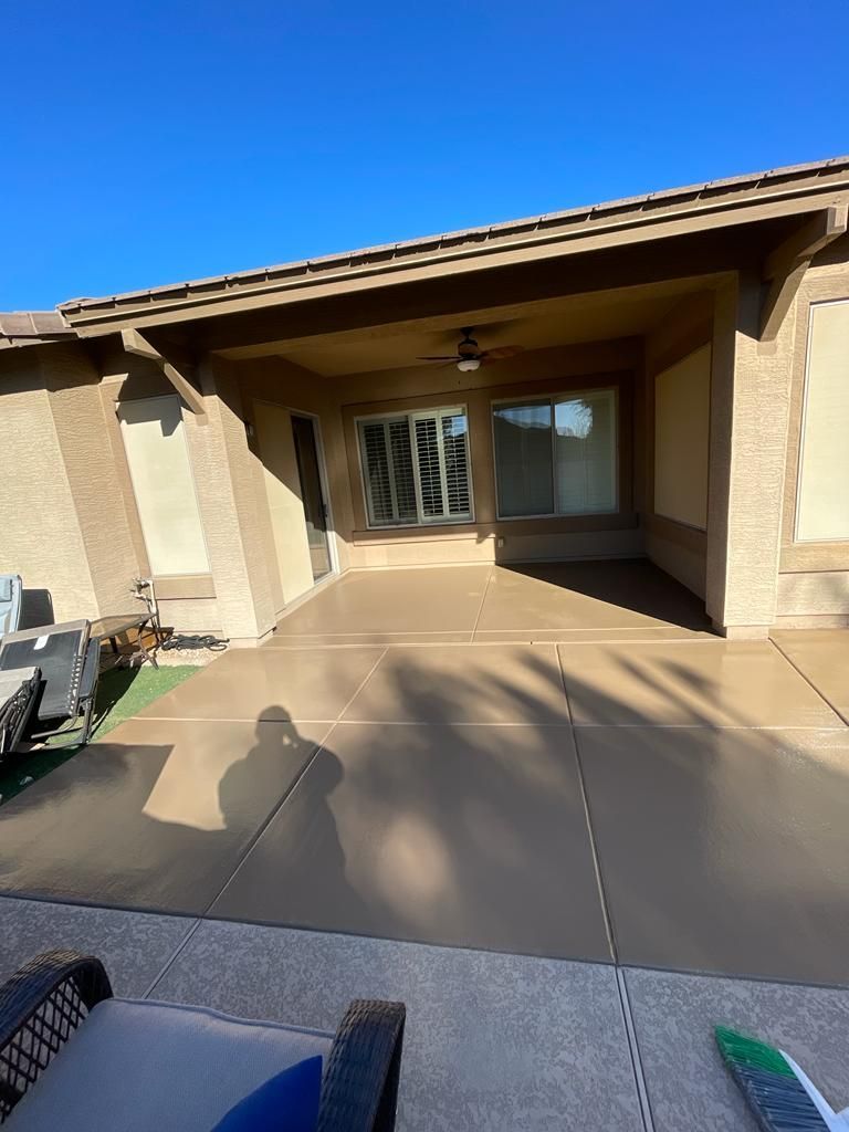 Covered patio with a concrete floor and a sliding glass door.