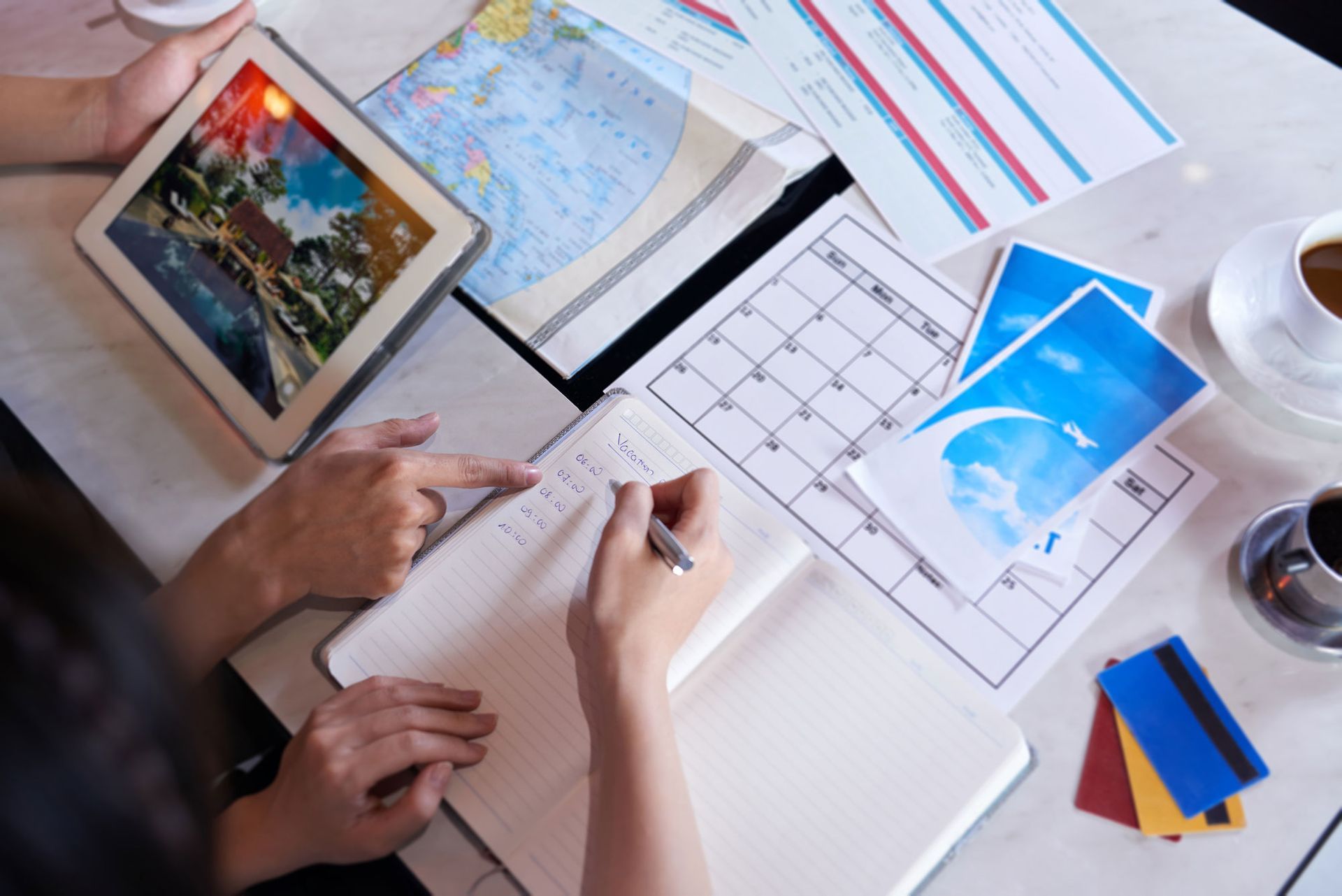 Couple are sitting at a table planning a trip.