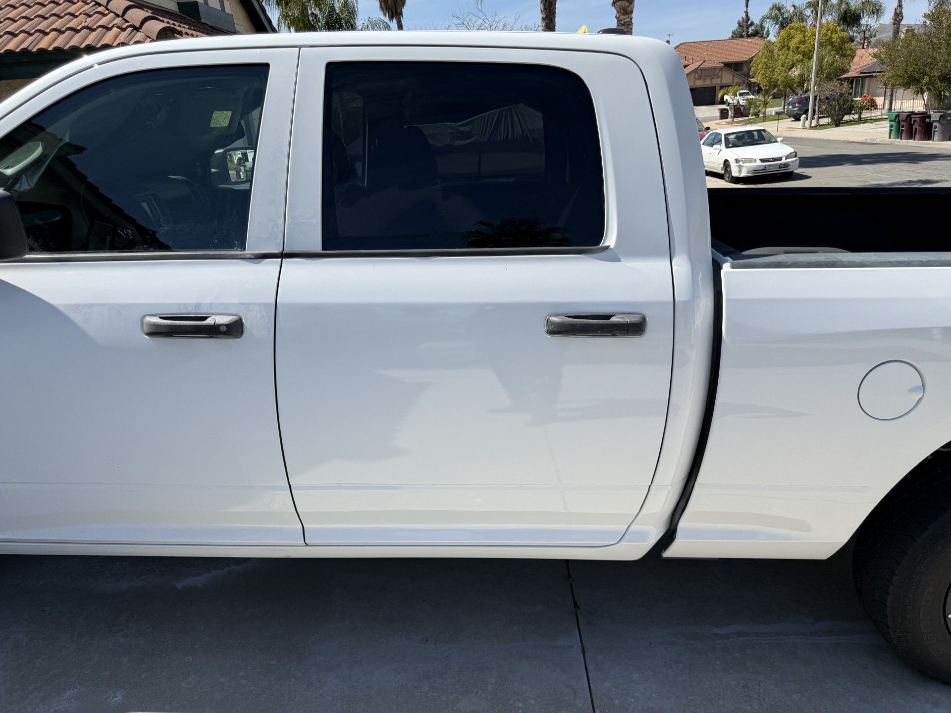 A white truck is parked on the side of the road
