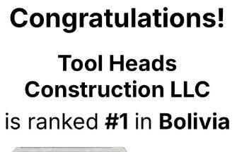 A person wearing work clothes, knee pads, and boots kneels while using a power drill on a wooden deck structure.