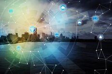 City skyline overlaid with a network of interconnected icons, symbolizing the Internet of Things.