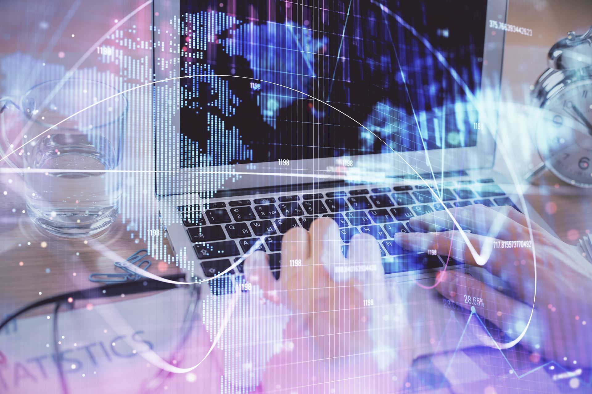 Person using a laptop with world map and data visualizations overlaid, with alarm clock in background.