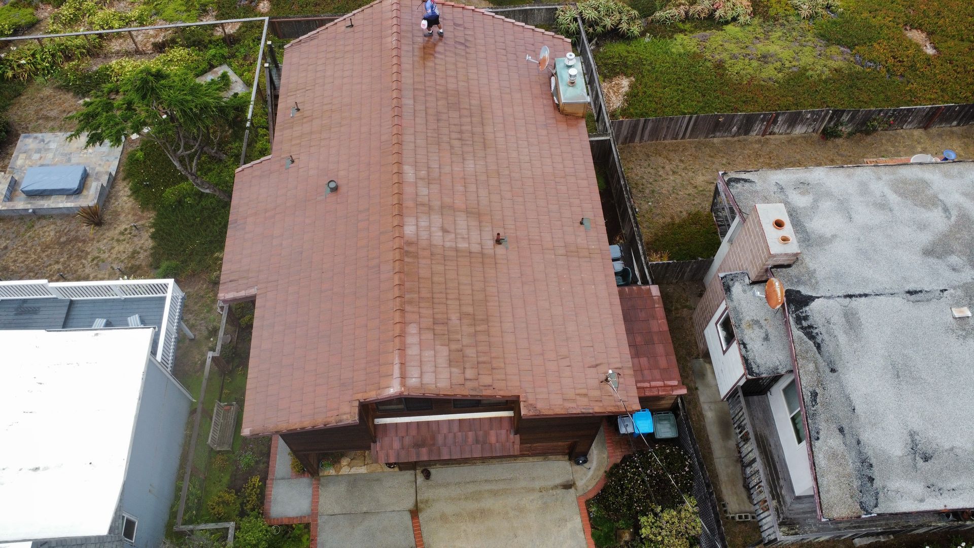 An aerial view of a house with a red tile roof.