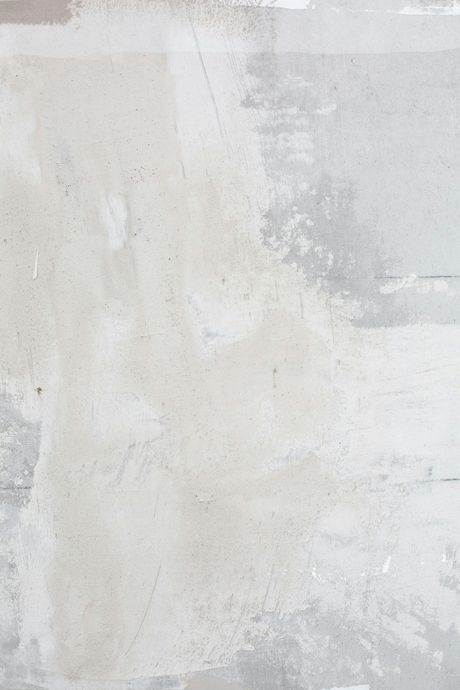 Textured, light gray and white concrete wall. Patches of lighter and darker shades create a weathered appearance.