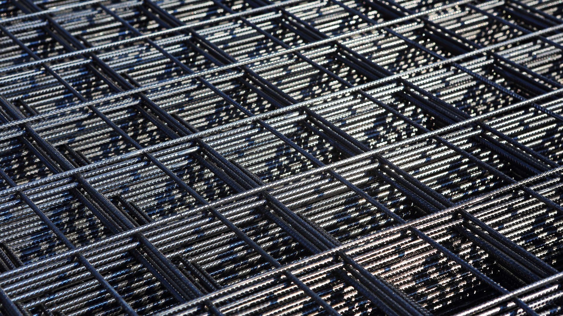 A close up of a metal grid with holes in it