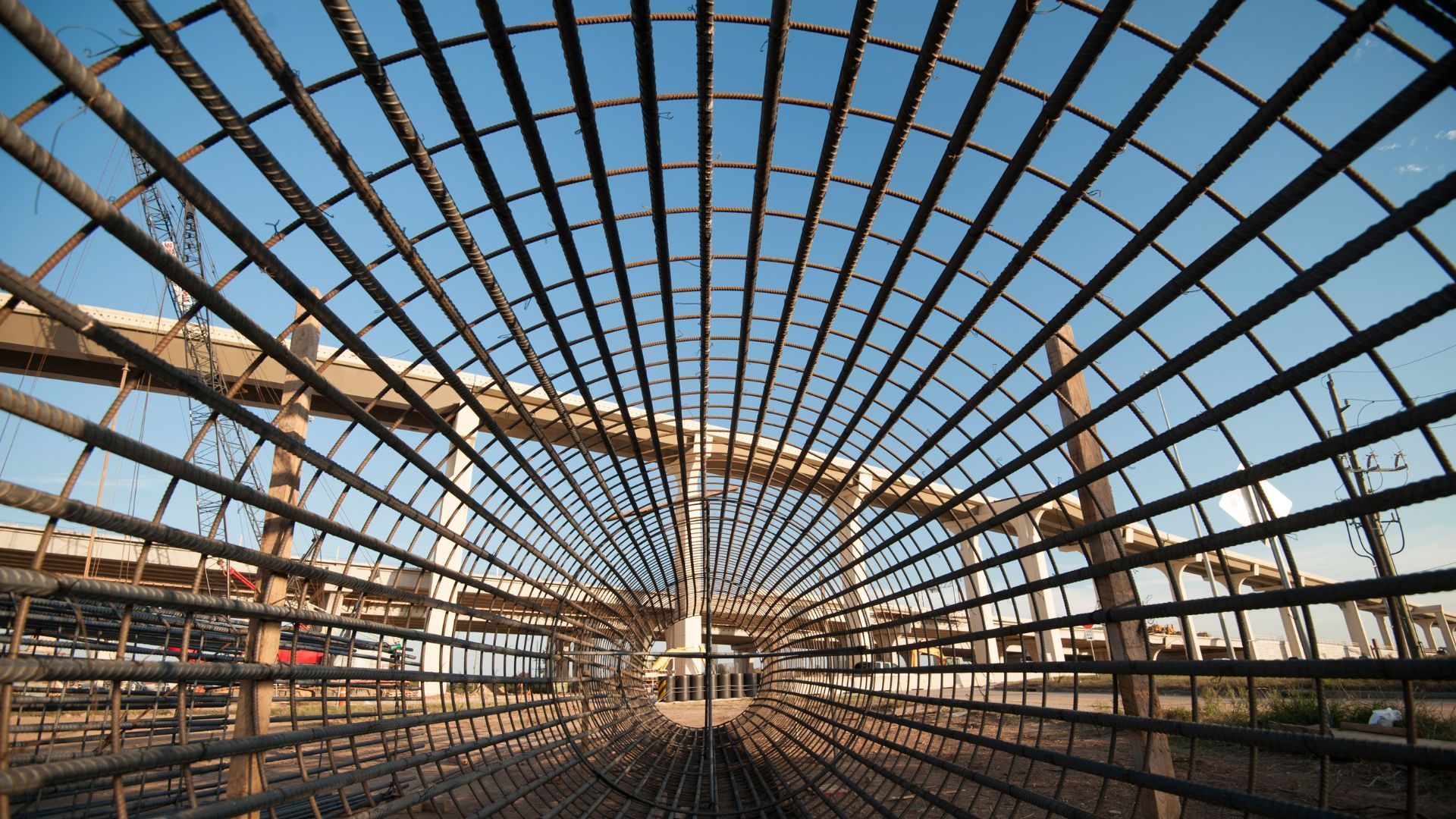 Looking up at a metal structure with a blue sky in the background