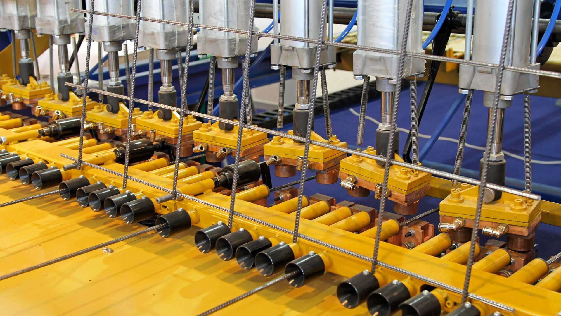 A bunch of yellow pipes are connected to a machine