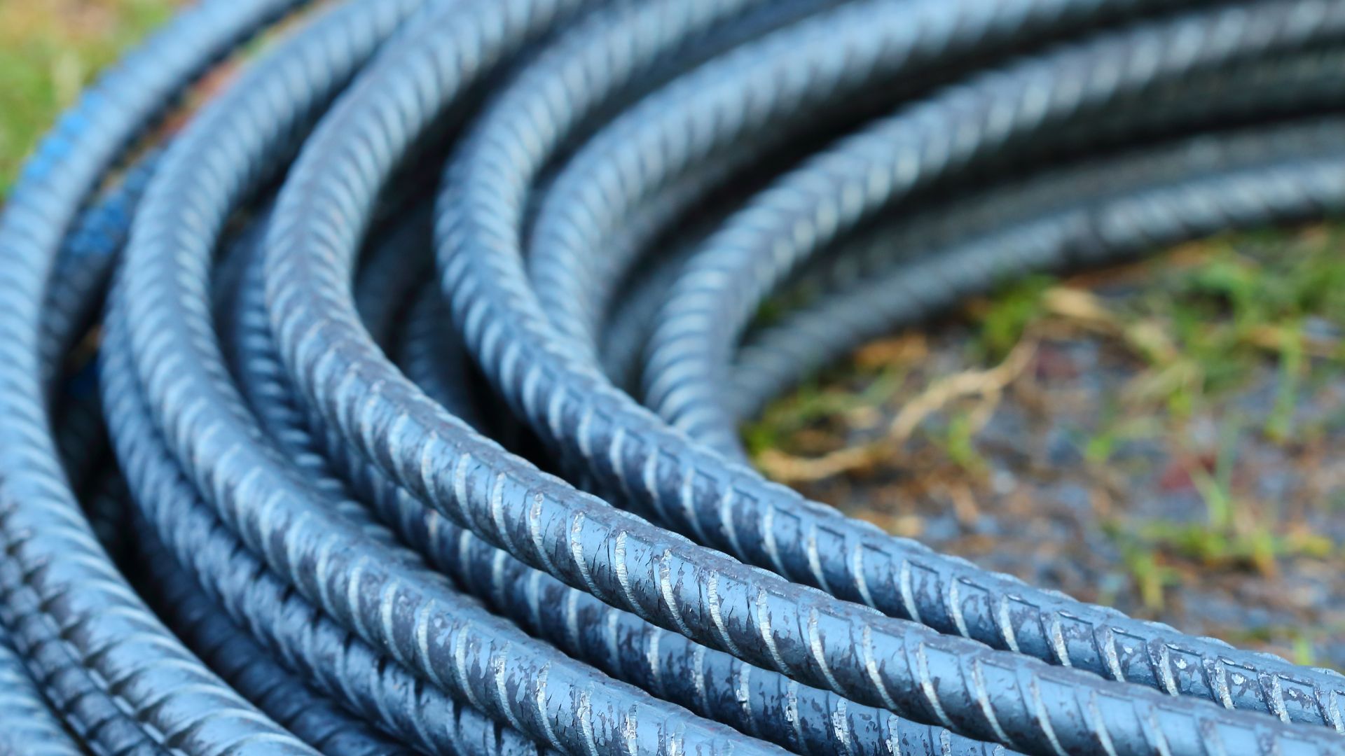 A close up of a coil of steel bars on the ground