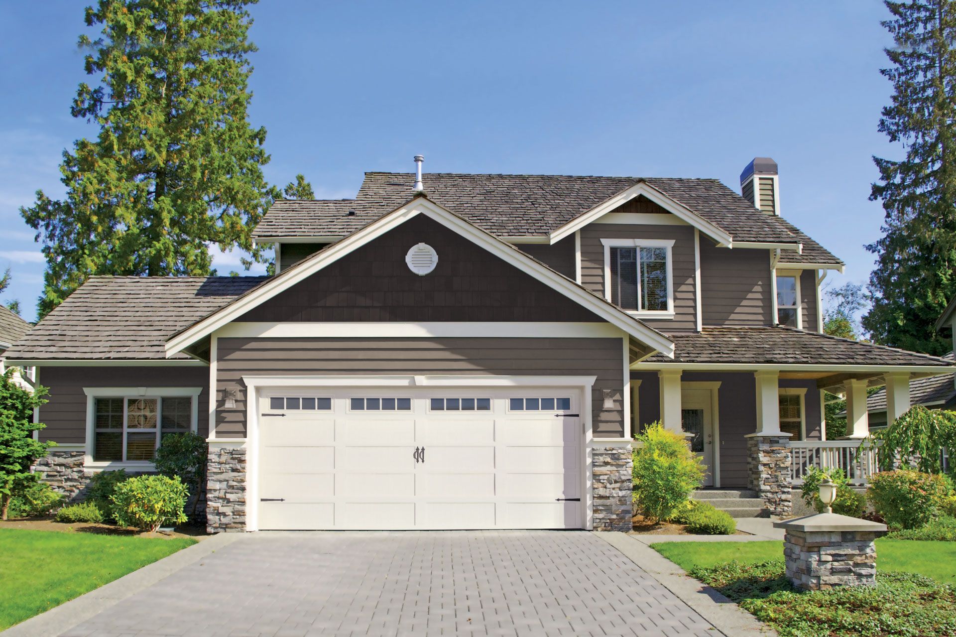 A large house with a white garage door