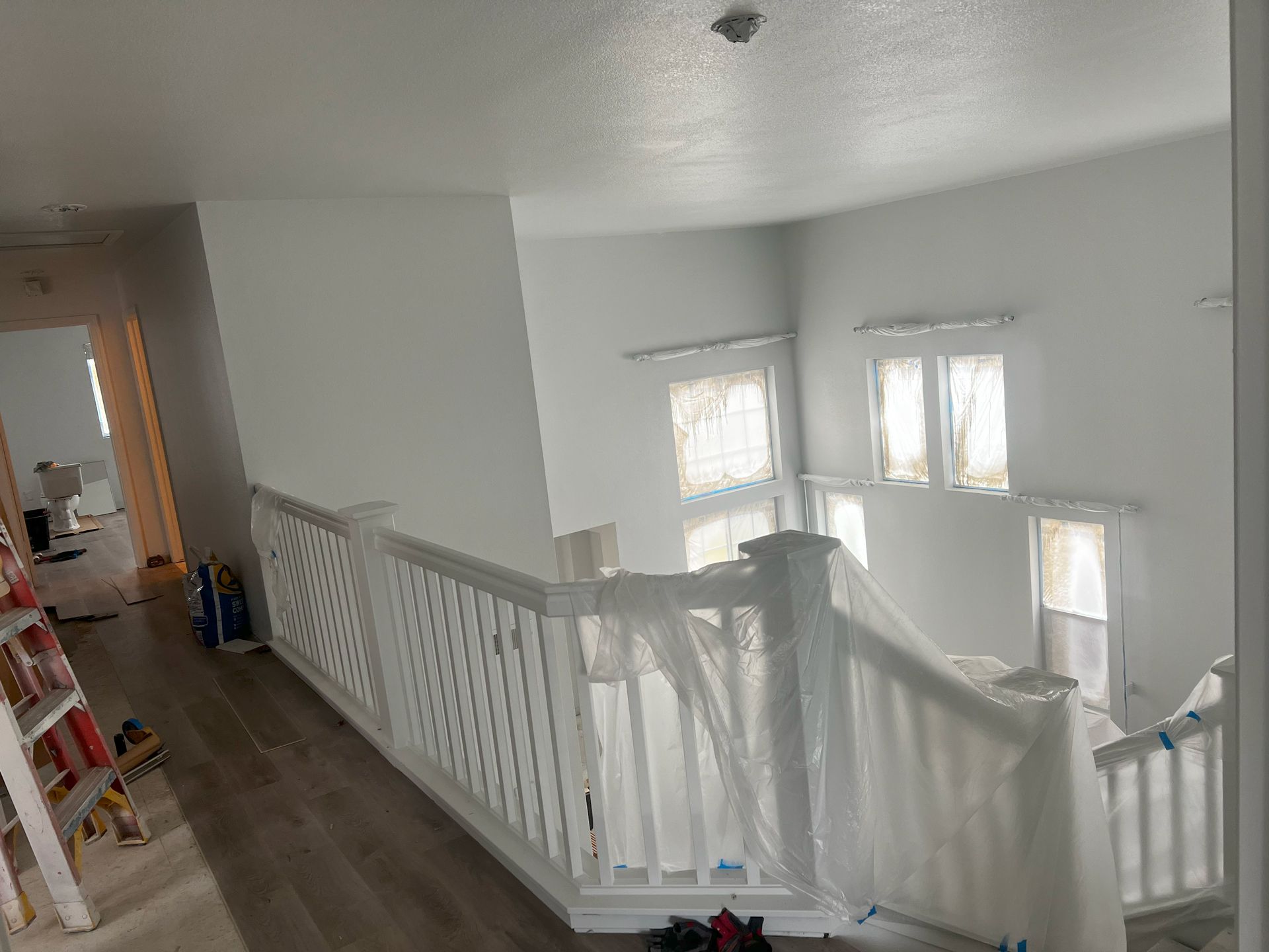 The stairs are being painted white and the railing is white