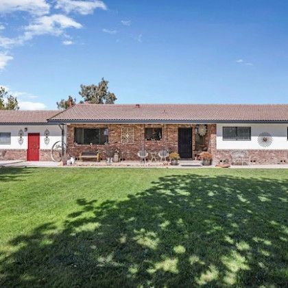A large house with a large lawn in front of it.