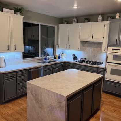 There is a large island in the middle of the kitchen.