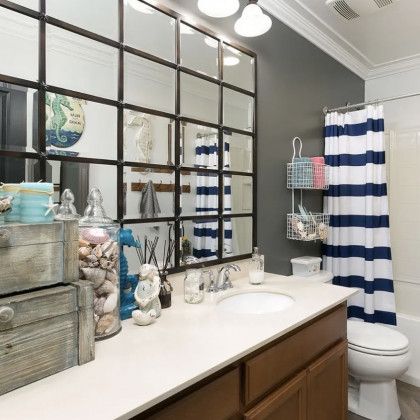 A bathroom with a sink , toilet and shower curtain