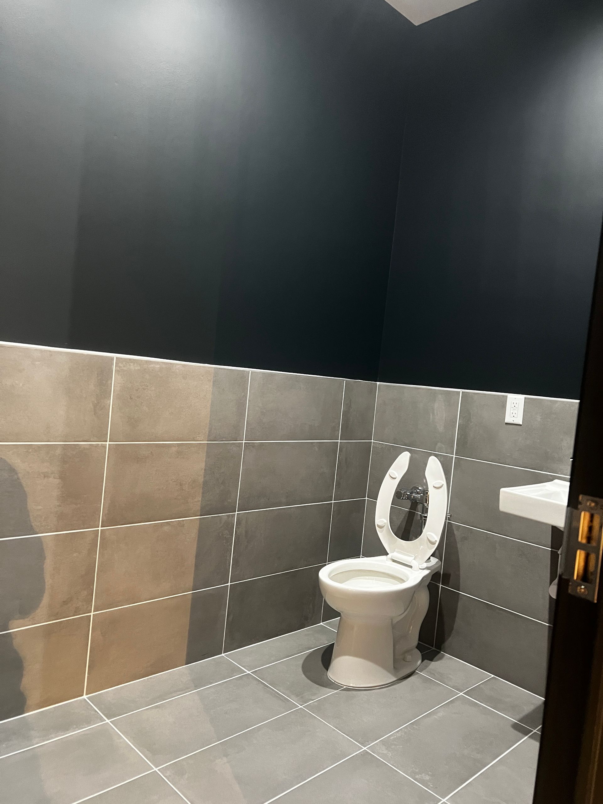 A bathroom with a toilet and a sink in it