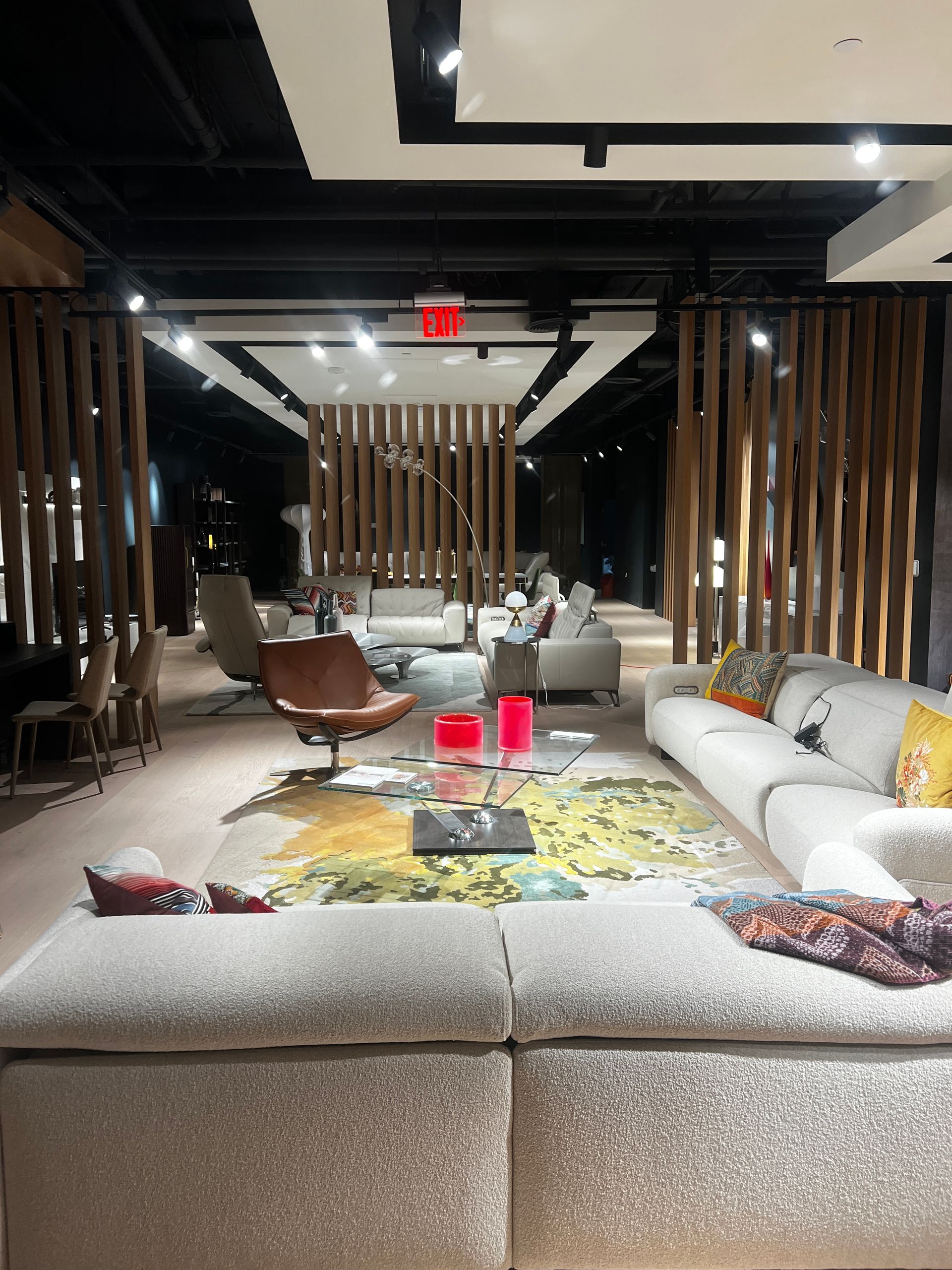 A living room filled with furniture and a red exit sign