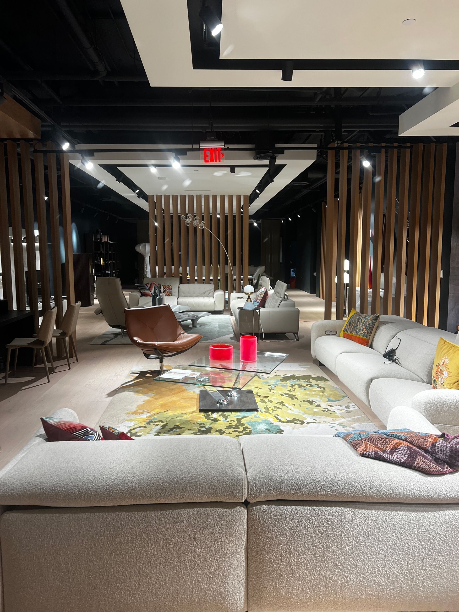 A living room filled with furniture and a red exit sign