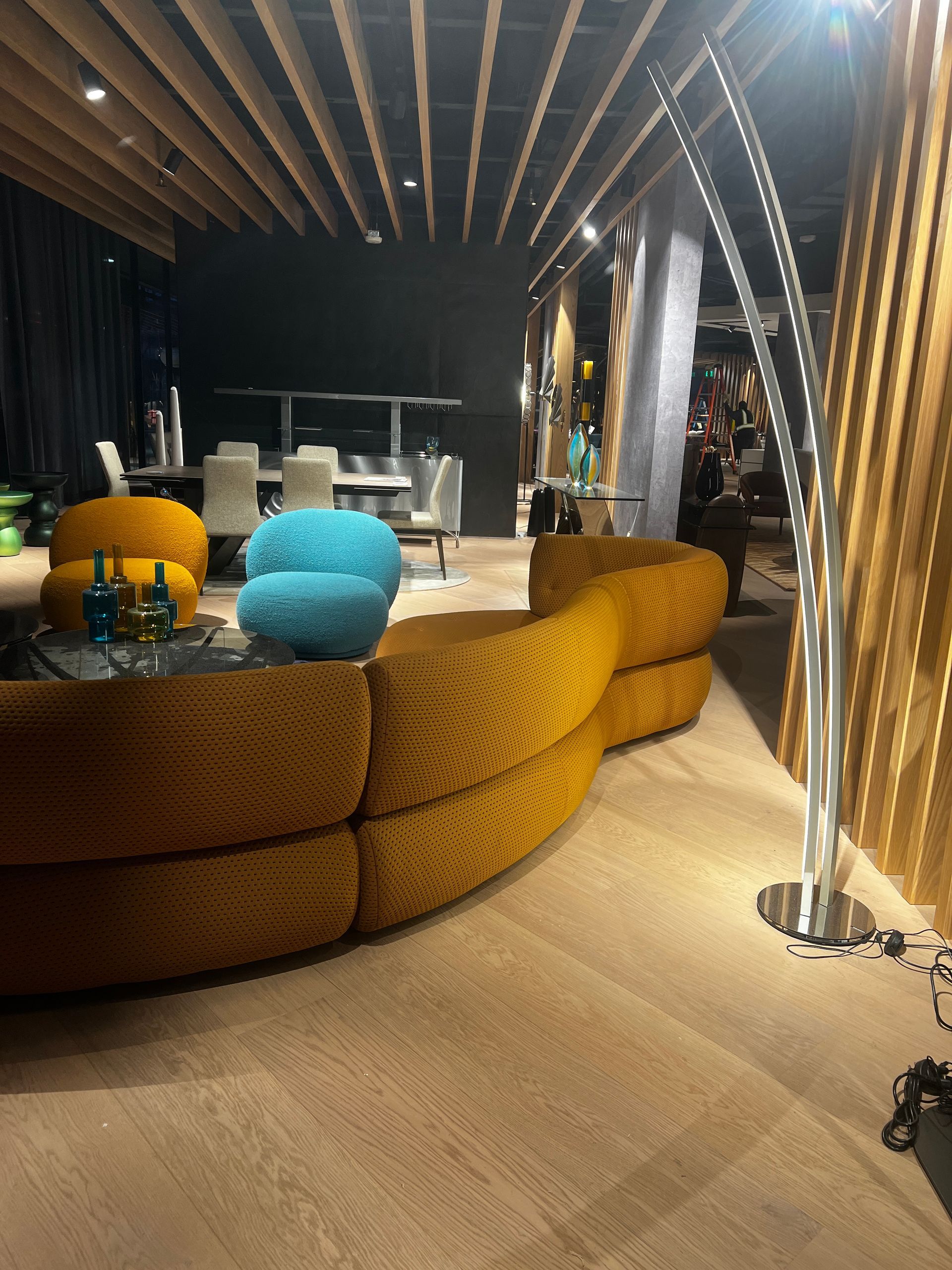 A living room with a yellow couch and blue chairs