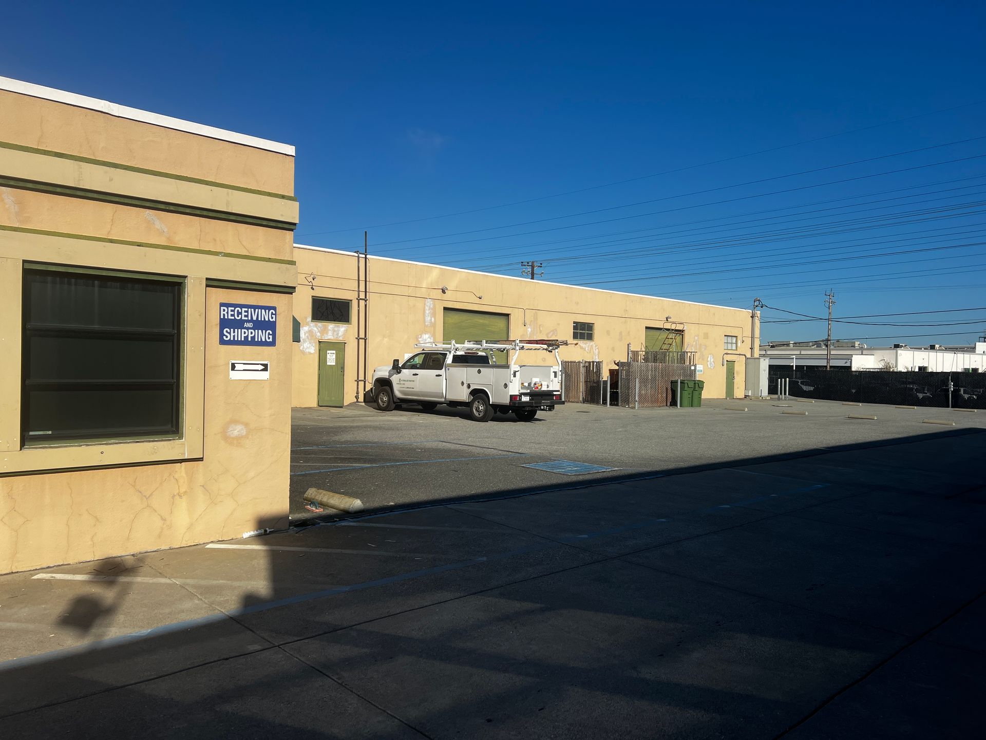 A white truck is parked in front of a building