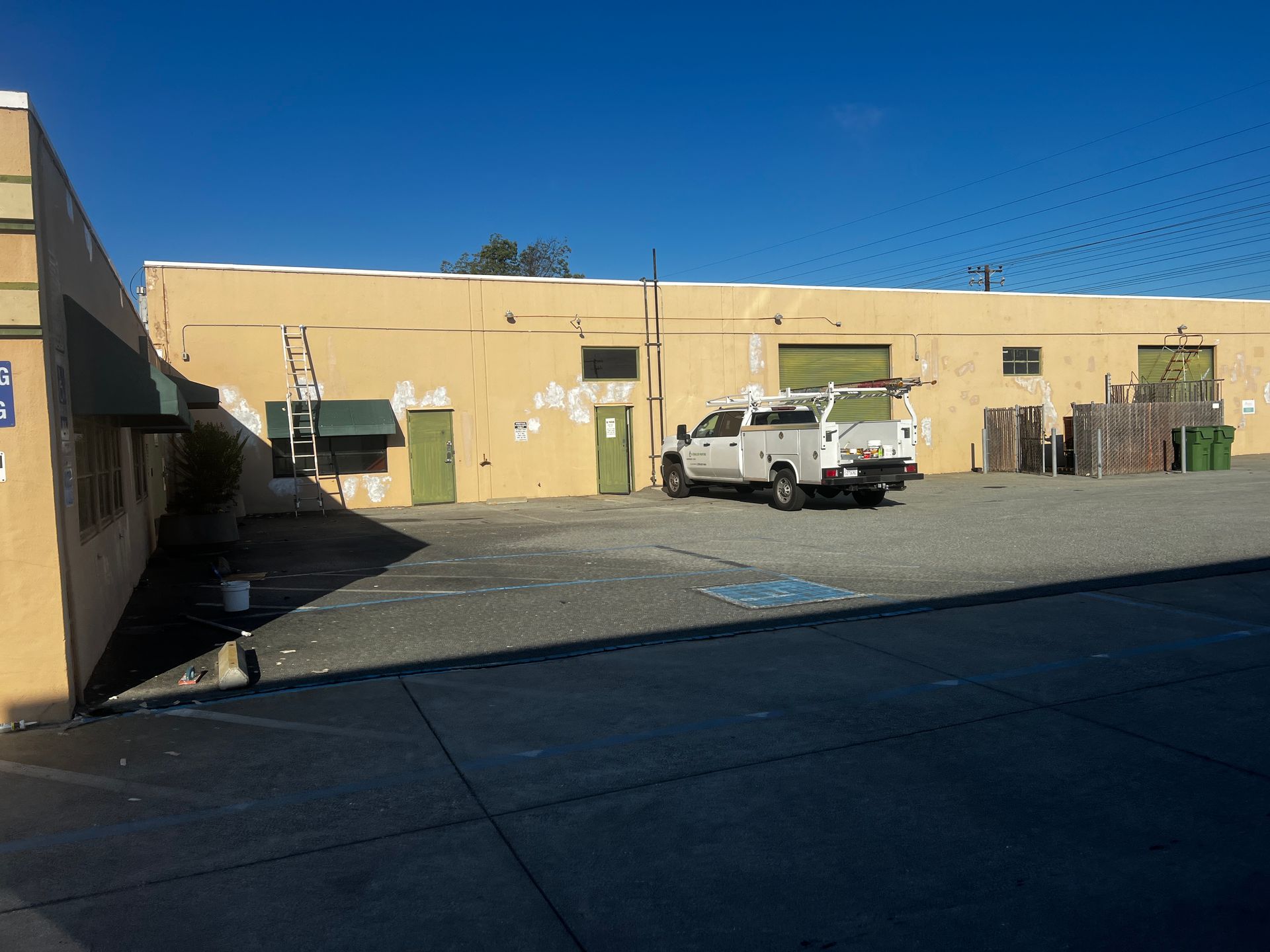 A white truck is parked in front of a building