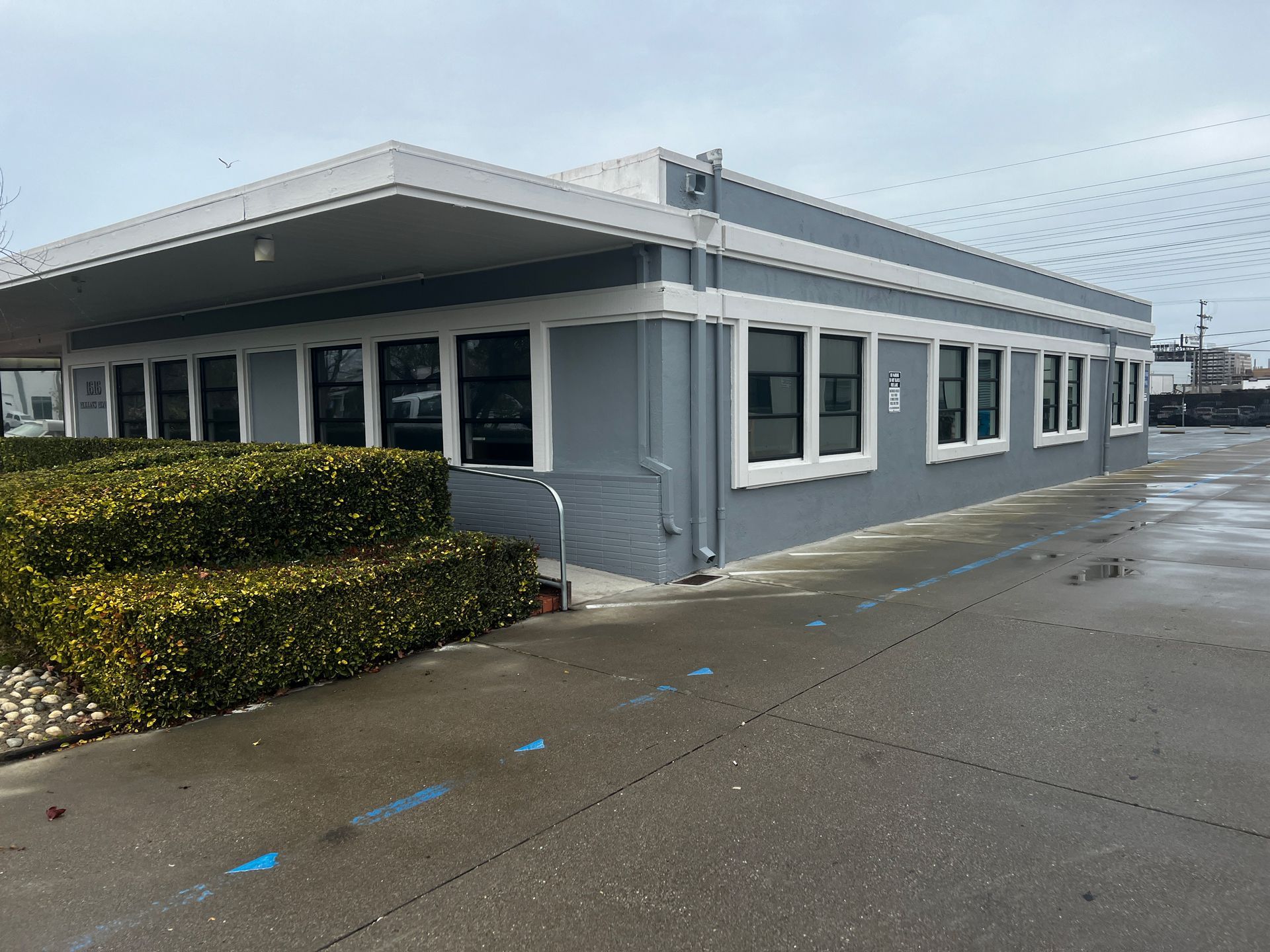 A Large Building With a Lot of Windows and a Handicapped Ramp